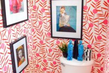 19 a colorful powder room with bold wallpaper and statement artworks plus statuettes is all about fun
