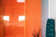 21 a modernist bathroom in bold orange, green, pink and grey plus teal textiles is a super colorful space