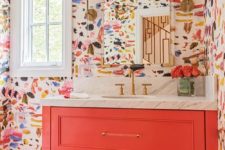23 a super colorful bathroom with bright brushstroke wallpaper, a coral vanity and bright blooms in a clear vase