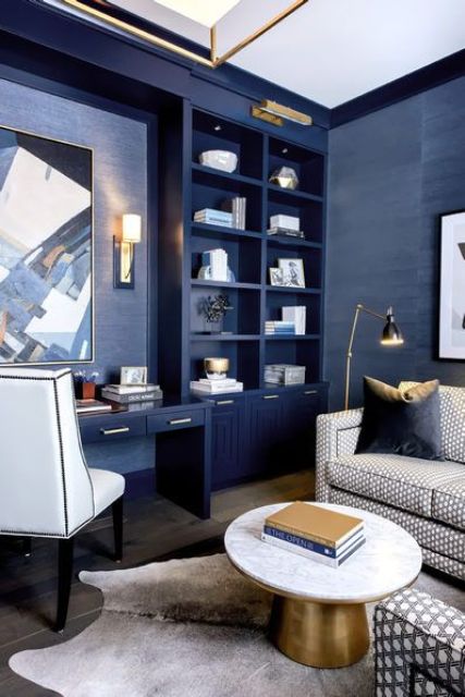 a bright home office done in bold blue, with elegant gold touches and some whites to refresh the space