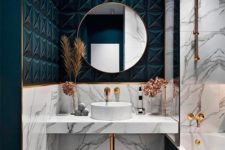 a chic bathroom with white marble and teal tiles, with gold accents and edges here and there for a refined touch