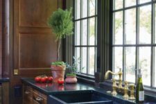 a gorgeous brown kitchen of natural wood and blue stone countertops and a built-in sink for a refined feel
