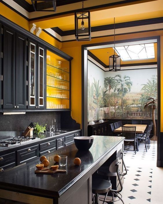 a large vintage kitchen done with yellow walls, black cabinetry and vintage furniture plus lamps makes a statement