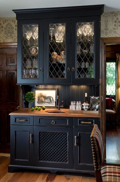 A midnight blue buffet with built in lights and light stained brown countertops for a chic and bold look