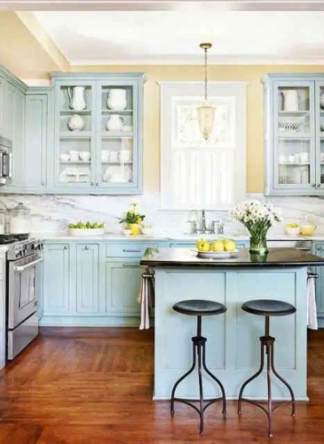 a tender pastel kitchen done in light blue and yellow, with touches of black and white for a bolder look