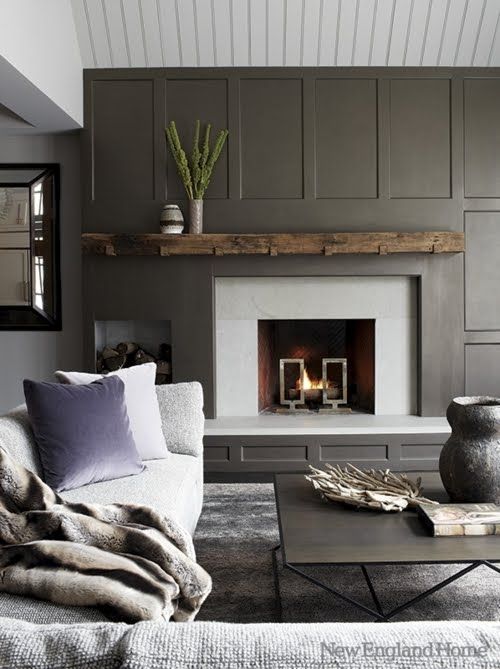 a welcoming modern living room with a grey paneled statement wall and a fireplace that stands out a lot