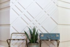 an ultra-modern entryway with white paneled walls that look catchy, add pattern and texture to the space