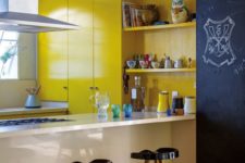 bright yellow cabinetry, a chalkboard wall, black stools, a white built-in kitchen island for a bold modern look