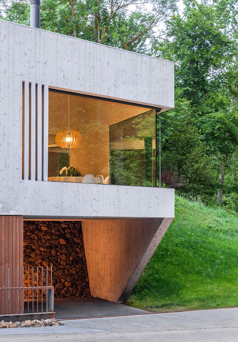 The house is clad with light colored wood, there are glazed walls that allow enjoying the views