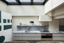 02 The kitchen is done with a marble backsplash, a glass roof that can be opened to outdoors anytime