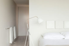03 The master bedroom is all-neutral, with closed and hidden storage, a large bed, floor lamps and neutral textiles