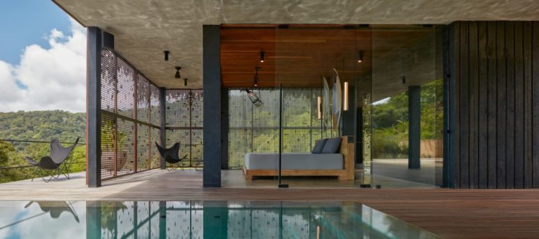 The spaces are indoor-outdoor, with a pool and a deck to which the indoor spaces open