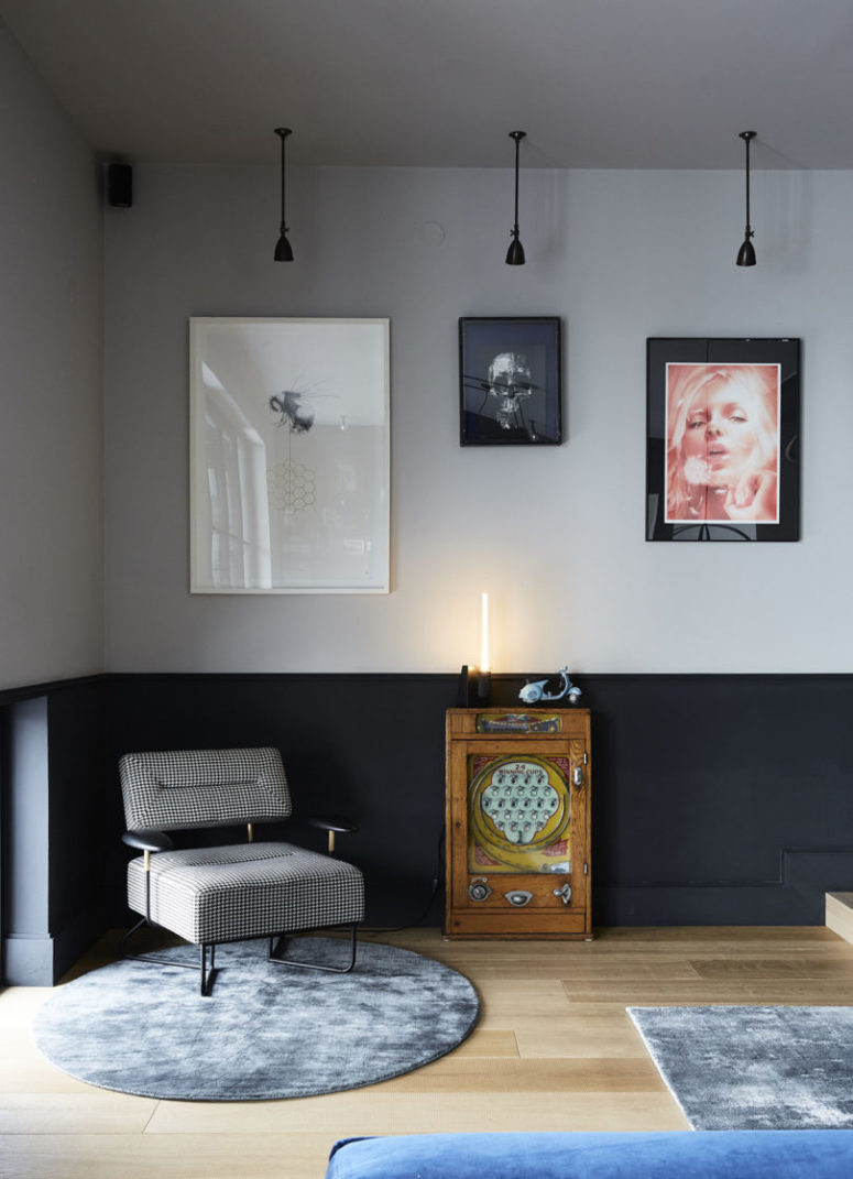 This nook features a unique gallery wall, pendant lamps, a little side table and a chic mid-century modern chair