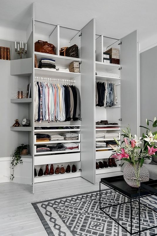 a stylish small built-in closet with shelves up and down and some holders for clothes hangers is a perfect idea