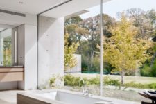 07 The bathroom features a built-in tub placed next to a glass wall to enjoy the views