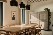 07 This is an indoor dining space with cool black lamps, black chairs, wooden furniture and black chairs