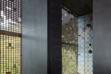 08 The shower spaces are done with the same bright tiles and there are perforated metal screens