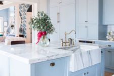 08 a beautiful and elegant light blue kitchen with white marble countertops that make a luxurious statement accenting the colors