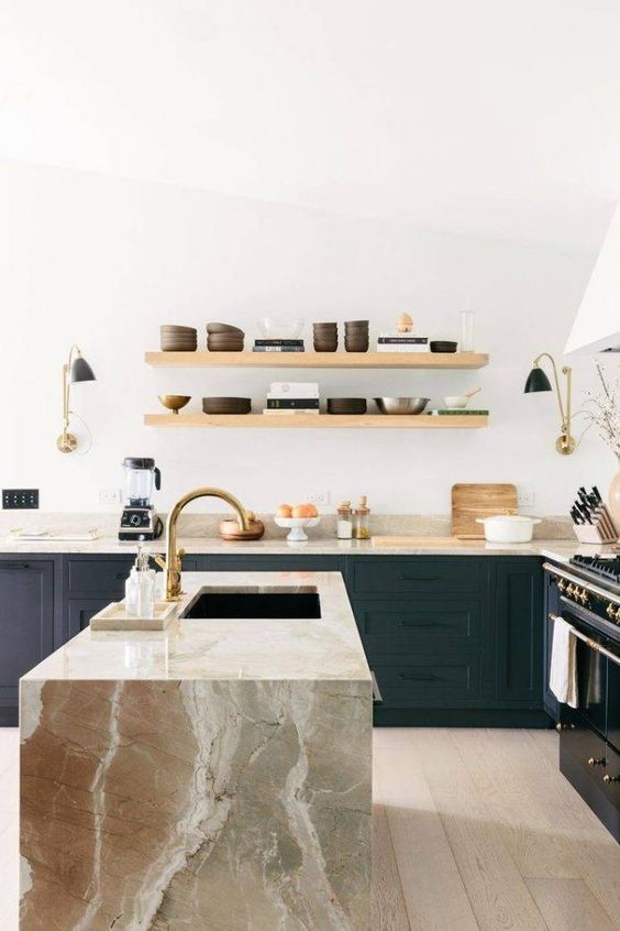 a black wooden kitchen highlighted with earthy-colored marble countertops including a waterfall one that make a real statement