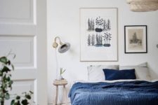 09 a gallery wall with various artworks is a cool idea for a contemporary bedroom, who needs a headboard