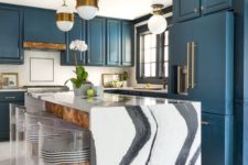 10 a chic blue kitchen and a kitchen island with a gorgeous white marble waterfall countertop that makes a statement here