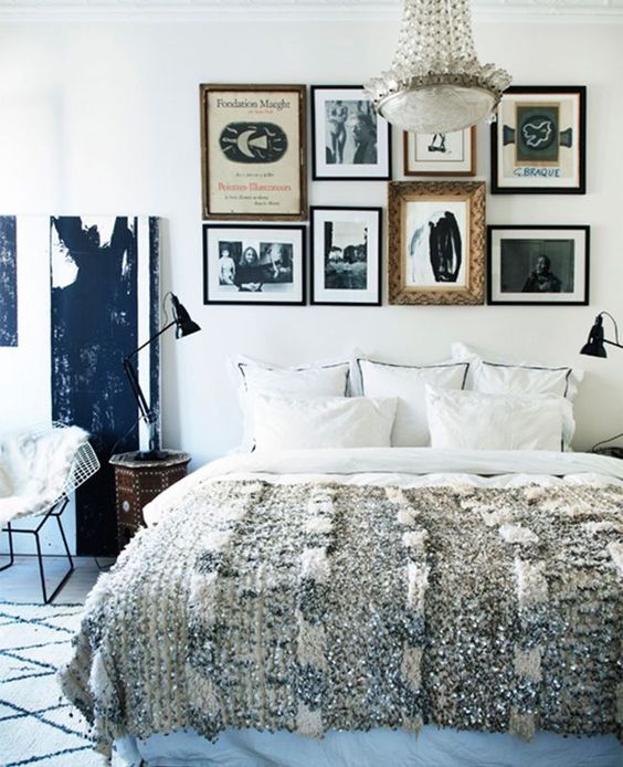 A gallery wall instead of a usual headboard is a catchy and bold idea to rock in your bedroom and personalize it a lot