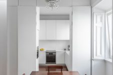 13 This kitchen is pure white and sleek, it’s small yet very functional