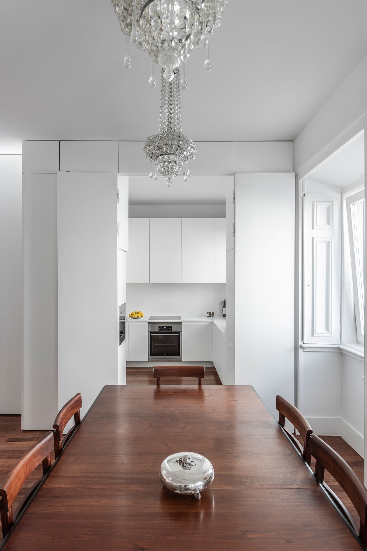This kitchen is pure white and sleek, it's small yet very functional
