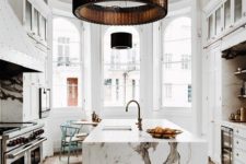 13 a luxurious white kitchen with a large kitchen island and a fantastic white marble countertop that wows at once
