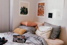 14 a pretty and bright gallery wall that hangs over the bed instead of a headboard and continues to the next wall