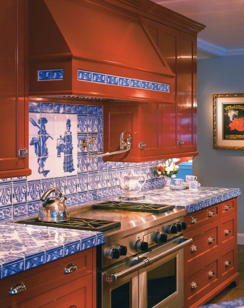 A rich stained kitchen of wood accented with blue tile countertops and a matching backsplash to make it bold