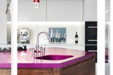24 a sleek minimalist white kitchen and a dark stained kitchen island with a fuchsia countertop that makes a bold statement here