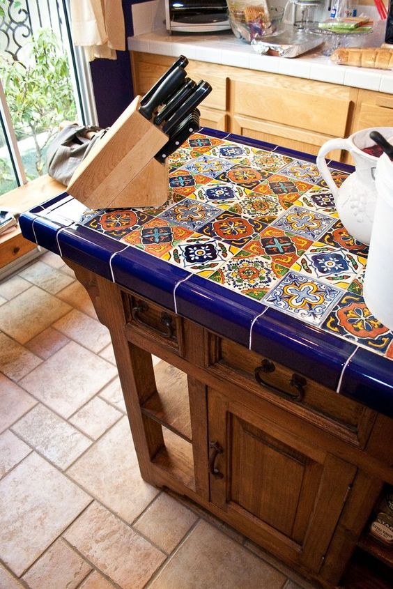 A vintage inspired wooden kitchen with a bright tile countertop that makes it outstanding and really bold and cool