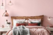 a chic contemporary bedroom with a pink statement wall, pink bedding, grey touches, pendant lamps and white furniture