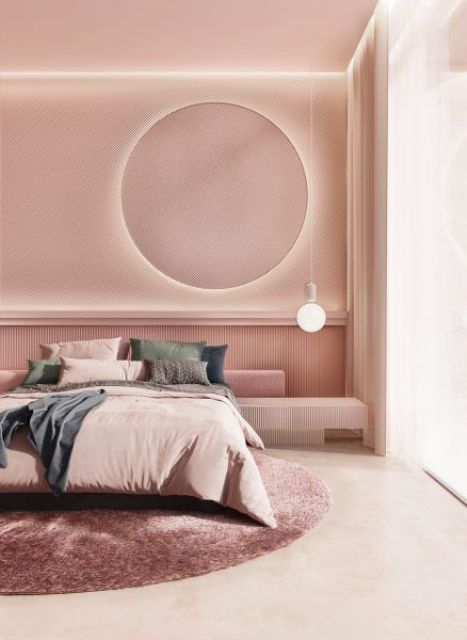 a chic modern bedroom with pink walls and a ceiling, with a round lit up mirror, a bulb, muted color bedding and a pink round rug