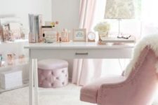 a glam home office in white and light pink, with pink curtains, a glam ottoman and a chair plus elegant prints