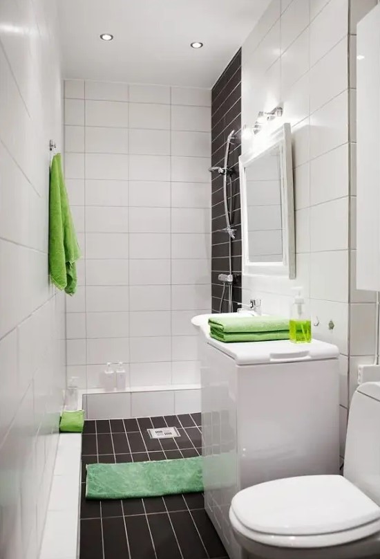 a laconic contemporary bathroom done with white and chocolate brown tiles and accented with bright green elements