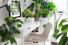 a neutral and airy home office with IKEA furniture, some simple artworks and potted tropical plants everywhere