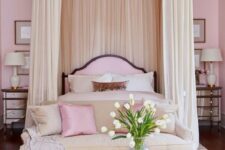 a refined light pink bedroom with a canopy bed and pink and neutral bedding, a neutral sofa and pillows, mirror nightstands