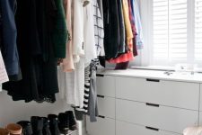 a small Scandinavian closet with a couple of drawers, a makeshift closet and shoe shelves, a shelf with bags is a cool idea