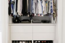 a small built-in closet with open shelves, drawers and rails with hangers is a perfect way to store a lot of things