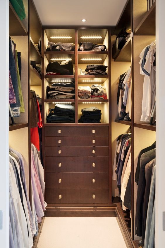 A small closet with open shelves and built in lights, drawers for storage is a clever and cool solution for your home