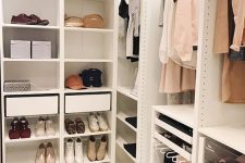 a small closet with open shelving, drawers, lights and some boxes is a very cool idea for anyone