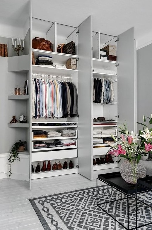 A stylish small built in closet with shelves up and down and some holders for clothes hangers is a perfect idea