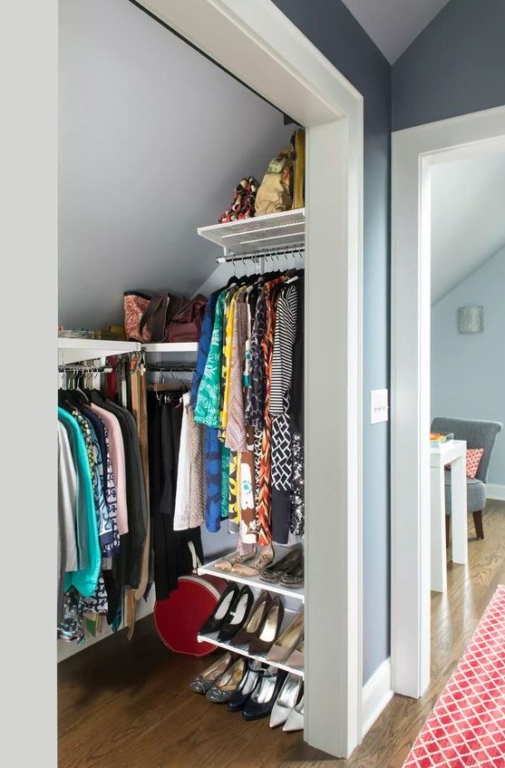 A tiny attic walk in closet with railings and shelves, with shoe shelves is a cool idea if you don't have much space
