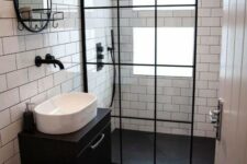 a tiny contrasting bathroom with windows in the shower, clad with white and black tiles, a black floating vanity and black touches here and there