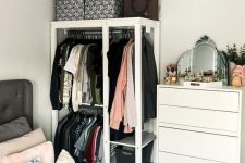 a tiny makeshift closet with rails, open shelves and a dresser next to it is a very smart and cool idea to rock