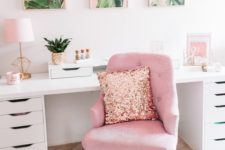 a tropical-inspired home office with a pink chair, a pink gallery wall and some more accessories in this amazing color