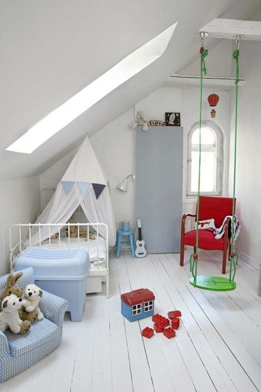 a white attic nursery with colorful furniture and toys, with a swing is very fun and veyr welcoming