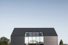 01 This black barn-like minimalist home makes a statement in the farmland region of Netherlands